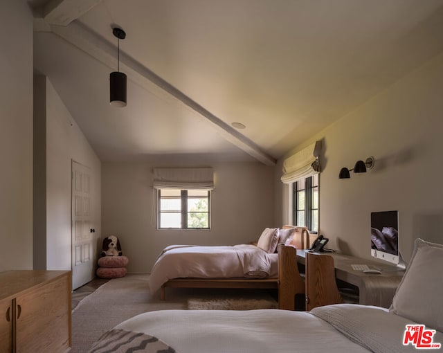 bedroom with lofted ceiling with beams and multiple windows