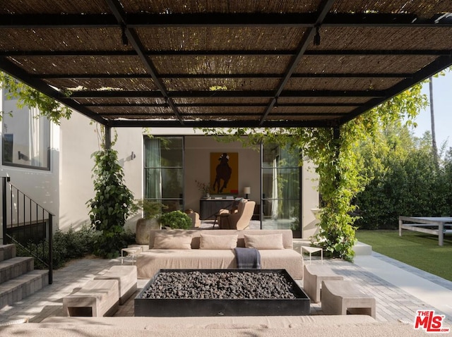 view of patio featuring an outdoor living space with a fire pit