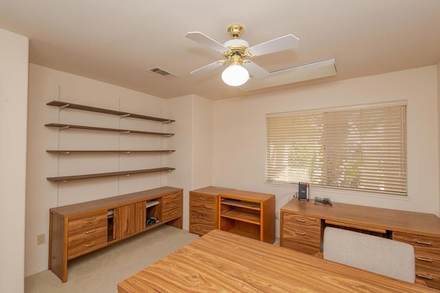 unfurnished office featuring light carpet and ceiling fan