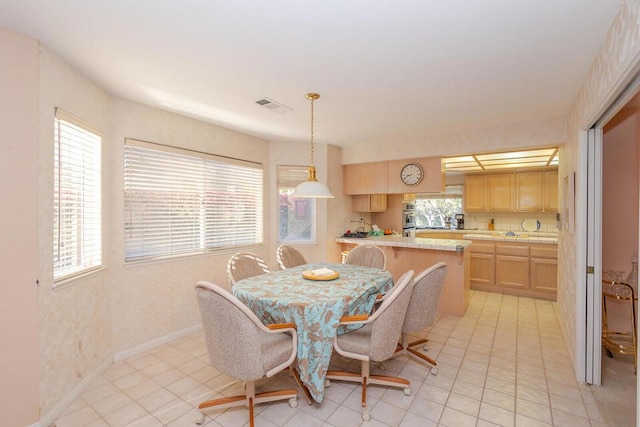 dining space featuring light tile patterned flooring