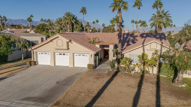 view of front of house with a garage and a mountain view