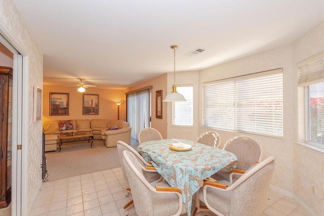 tiled dining room with ceiling fan