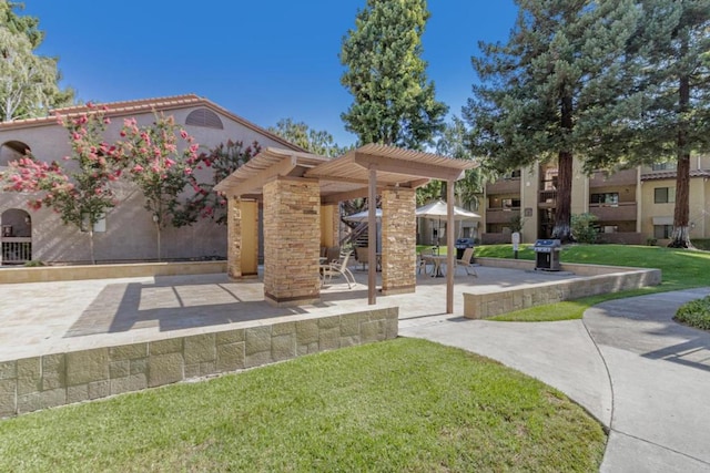 view of home's community with a lawn, a patio area, and a pergola