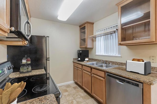 kitchen with sink, stainless steel appliances, and light stone countertops