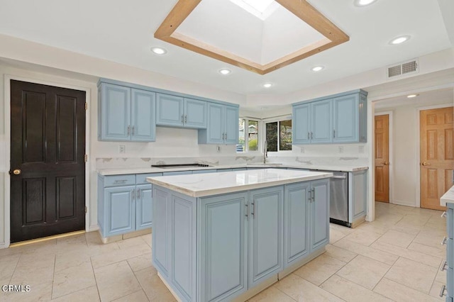 kitchen with blue cabinets, a kitchen island, black electric stovetop, and a skylight