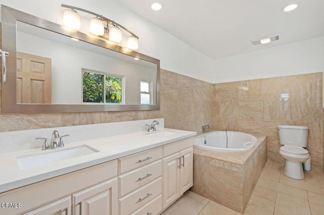 bathroom featuring tile walls, tile patterned flooring, vanity, toilet, and tiled tub