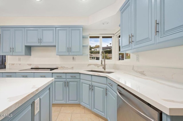 kitchen with blue cabinetry, stainless steel dishwasher, and sink