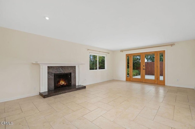 unfurnished living room featuring a premium fireplace