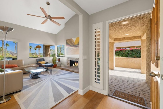 living room featuring high vaulted ceiling, plenty of natural light, light hardwood / wood-style floors, and ceiling fan