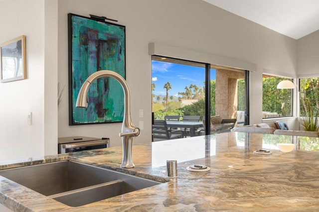 kitchen featuring stone countertops and sink