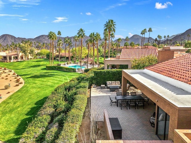 exterior space featuring an outdoor living space, exterior bar, and a mountain view