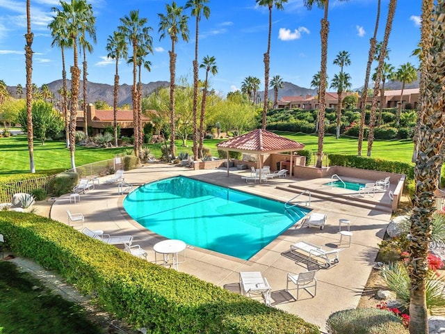 view of pool featuring a mountain view, a gazebo, a community hot tub, and a patio