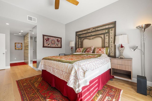 bedroom with ceiling fan and light wood-type flooring