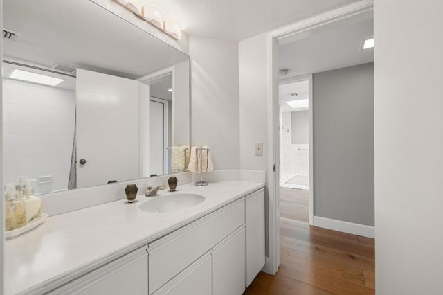 bathroom with vanity and wood-type flooring