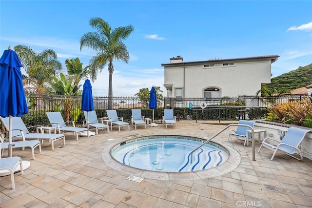 view of pool featuring a hot tub and a patio area