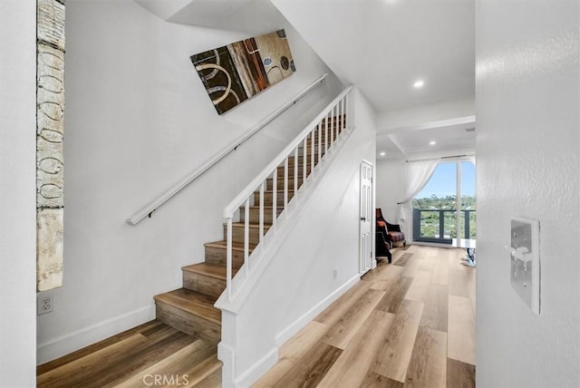 stairway with hardwood / wood-style flooring