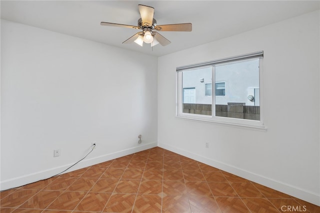 empty room featuring parquet floors and ceiling fan