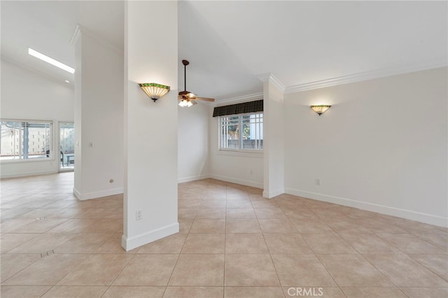 tiled empty room with crown molding, a skylight, high vaulted ceiling, and ceiling fan