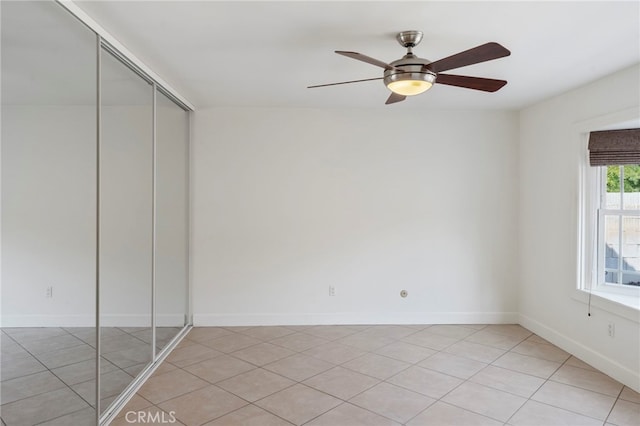 unfurnished bedroom with a closet, ceiling fan, and light tile patterned flooring