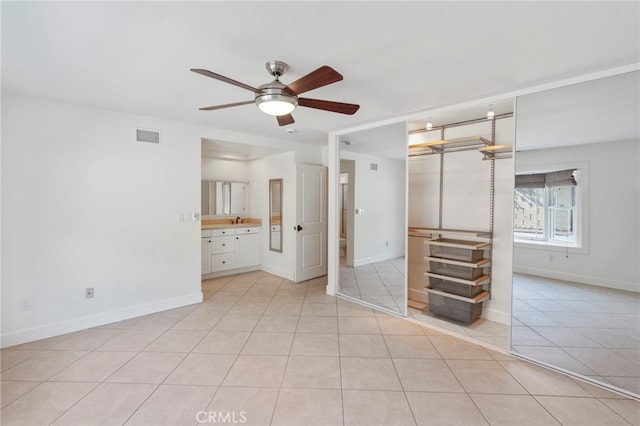 unfurnished room featuring ceiling fan and light tile patterned floors