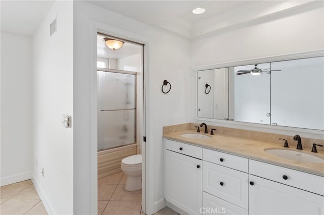 full bathroom featuring vanity, combined bath / shower with glass door, tile patterned floors, and toilet