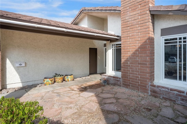 doorway to property featuring a patio area