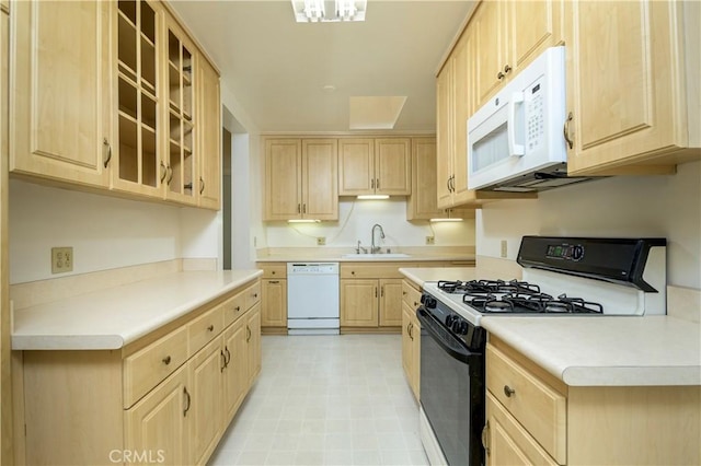 kitchen featuring sink, white appliances, and light brown cabinets