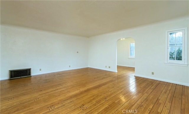 unfurnished living room featuring a healthy amount of sunlight and light wood-type flooring