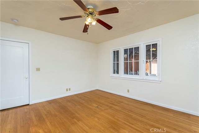 spare room with hardwood / wood-style floors and ceiling fan