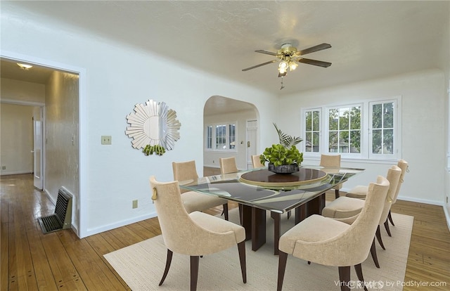 dining room with ceiling fan and hardwood / wood-style floors