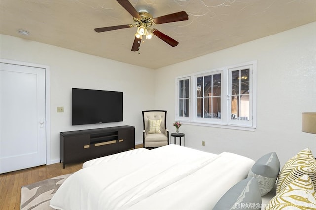 bedroom with ceiling fan and hardwood / wood-style floors