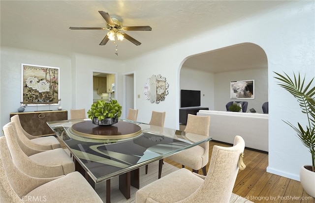 dining area with hardwood / wood-style flooring and ceiling fan