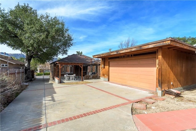 view of front of property with a garage, a gazebo, and an outdoor structure