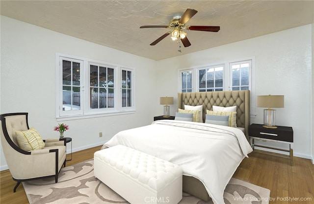 bedroom featuring wood-type flooring and ceiling fan