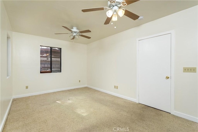 carpeted spare room with ceiling fan