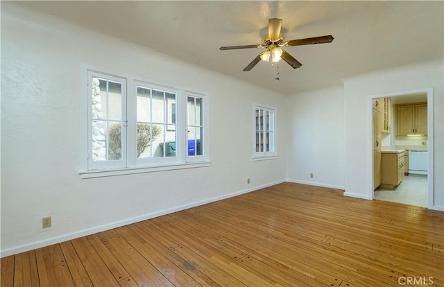 empty room featuring light hardwood / wood-style flooring and ceiling fan