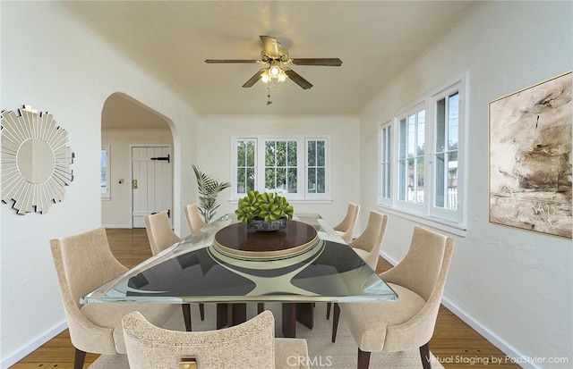 dining area with wood-type flooring and ceiling fan