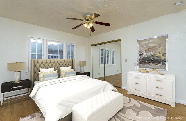 bedroom with wood-type flooring, a closet, and ceiling fan