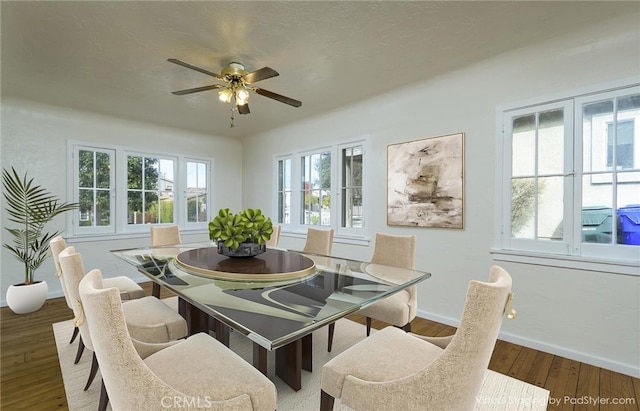 dining room featuring ceiling fan, wood-type flooring, and a textured ceiling