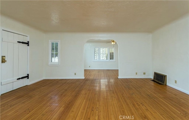 spare room featuring light hardwood / wood-style flooring and ceiling fan