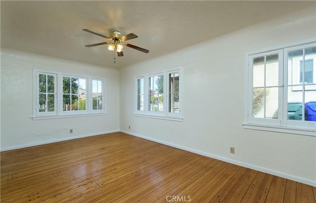 spare room featuring ceiling fan and light hardwood / wood-style flooring