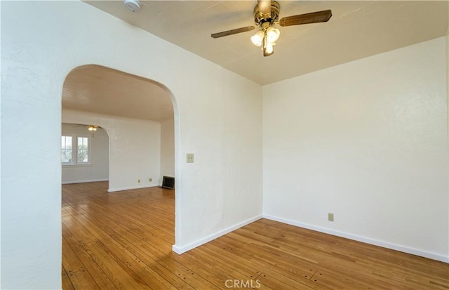 spare room featuring hardwood / wood-style floors and ceiling fan