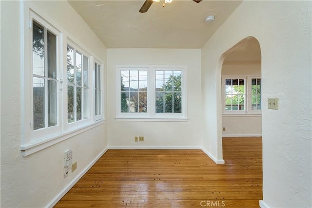 empty room featuring hardwood / wood-style floors and ceiling fan