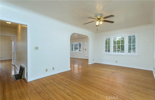 empty room with ceiling fan and light wood-type flooring