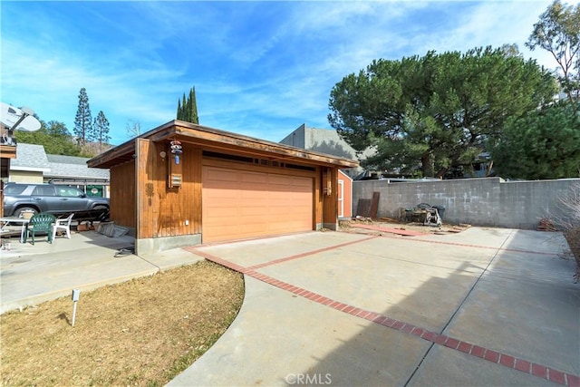 view of home's exterior with a garage and an outdoor structure