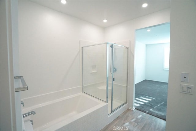 bathroom featuring wood-type flooring and independent shower and bath