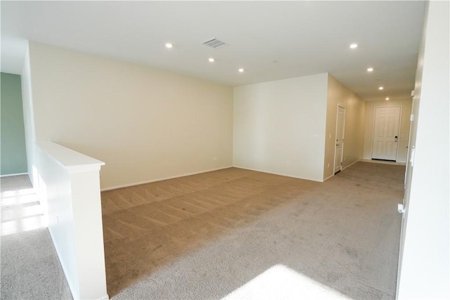 unfurnished room featuring light colored carpet