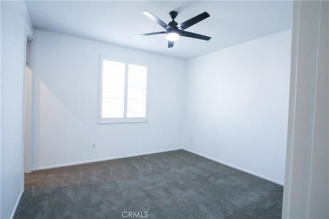 unfurnished room featuring dark carpet and ceiling fan