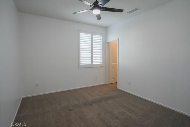 carpeted spare room with ceiling fan