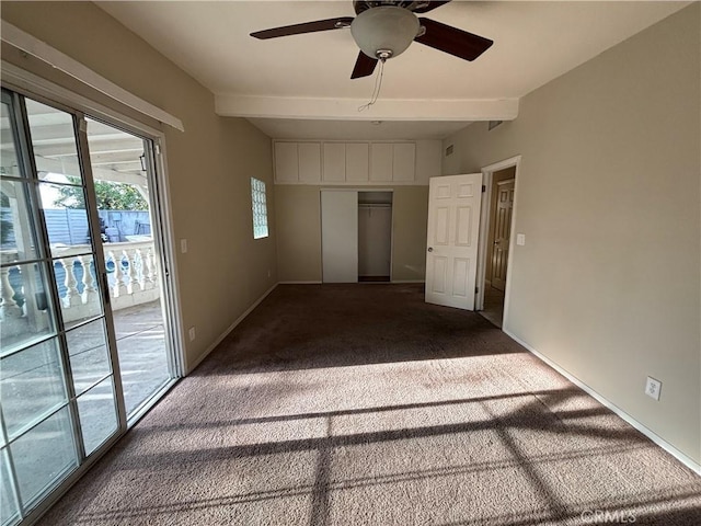 unfurnished bedroom with carpet flooring, access to exterior, ceiling fan, beam ceiling, and a closet